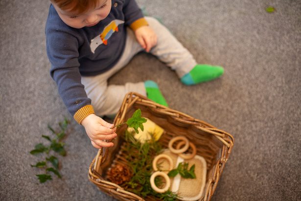 Baby with a treasure basket