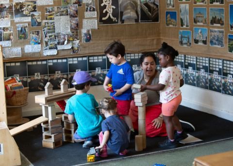 Group of young children playing with blocks