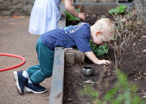 Small boy playing in the dirt
