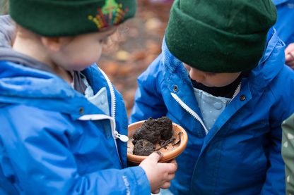 Small boys playing with dirt