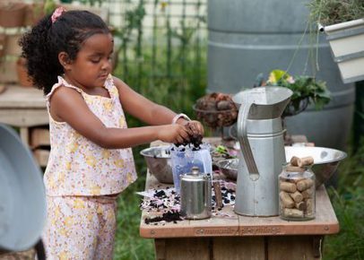Young child playing with dirt outside