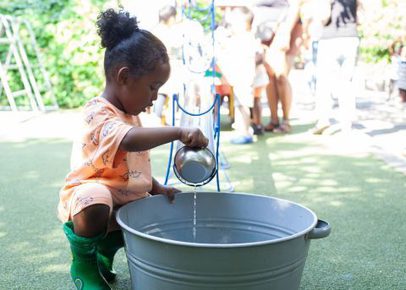 Young child playing with water