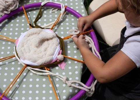 Young child weaving