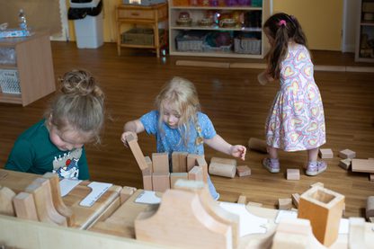 Young children playing with wooden blocks