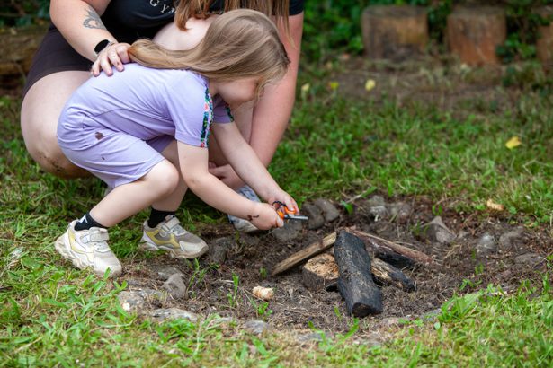Young girl at a camp fire